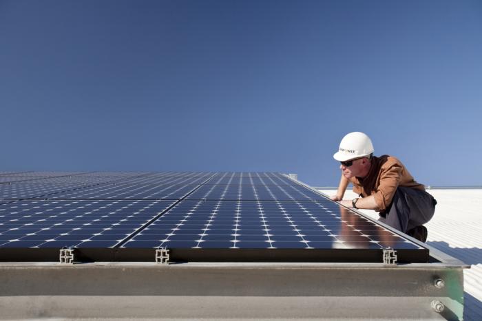 SunPower installer inspecting solar panels